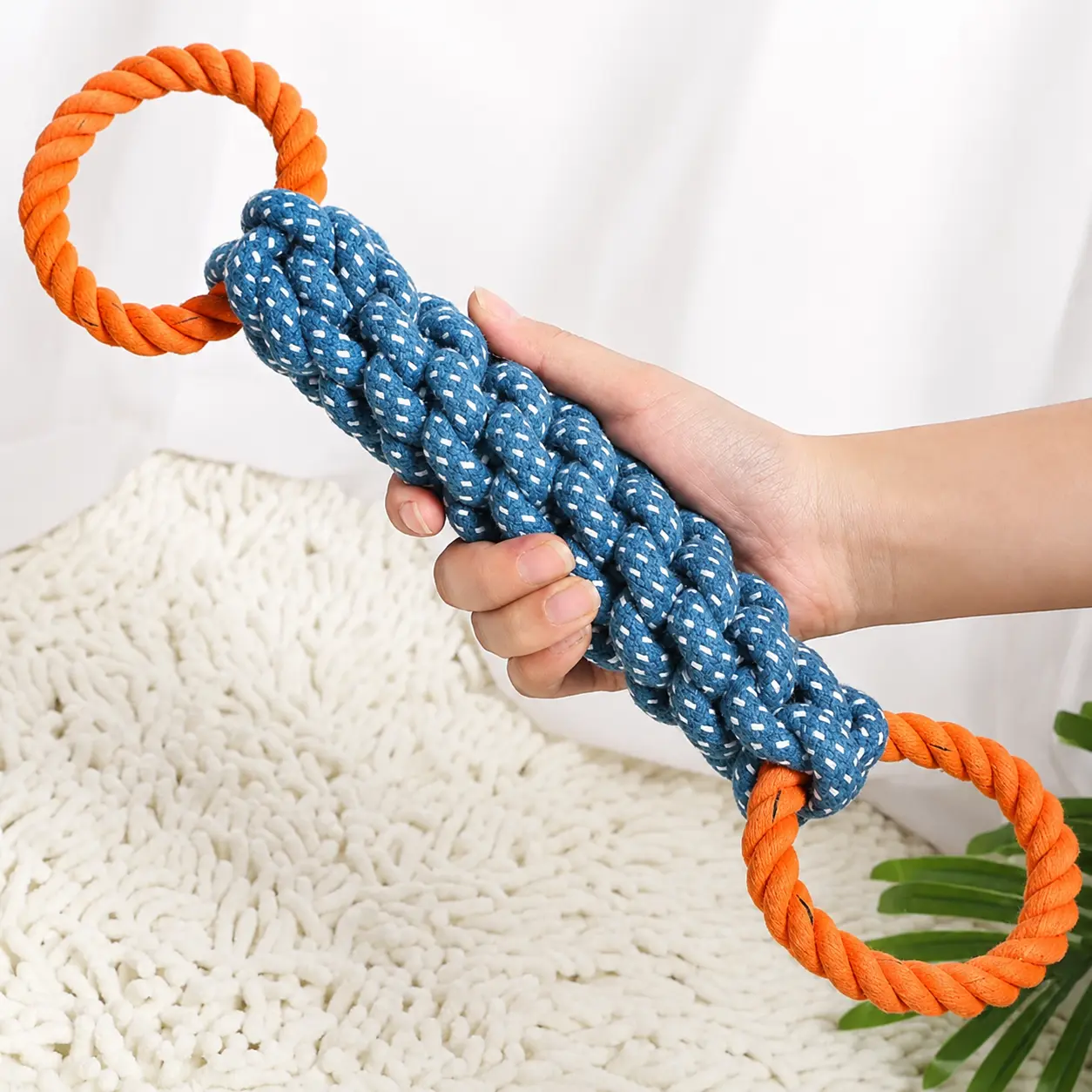 Dog tug rope toy with orange ring handle for interactive play