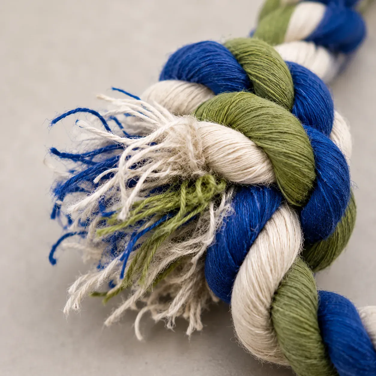 Frayed rope toy with loose threads, a warning sign it's time to replace it