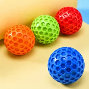 Honeycomb squeaky dog ball in orange, green, red, and blue color options