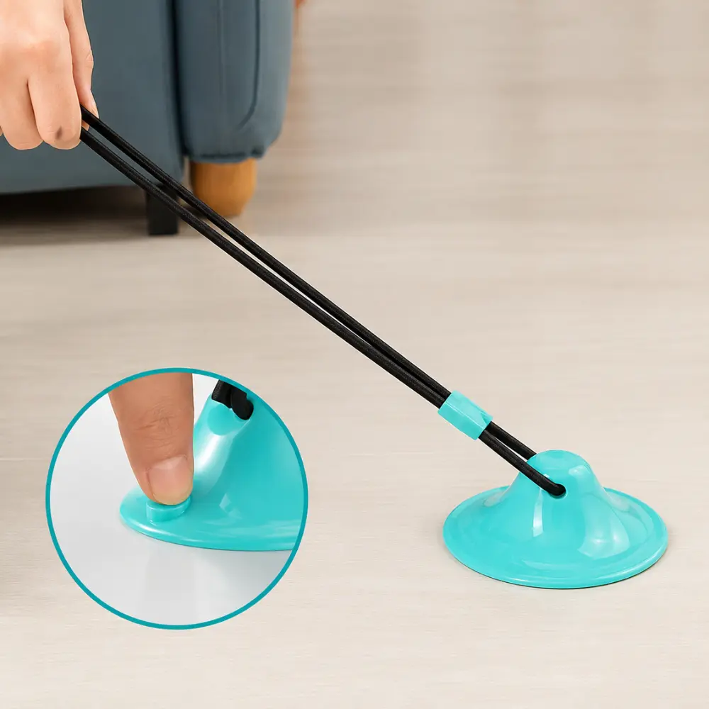 Hand pressing a suction cup dog toy firmly onto a smooth floor
