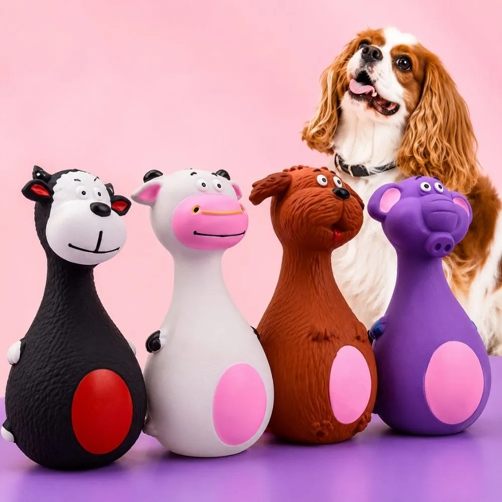 Four rubber squeaky dog toys in donkey, cow, dog, and elephant shapes with a spaniel