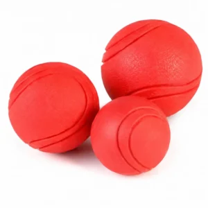 Solid rubber dog ball in red, durable chew and fetch toy
