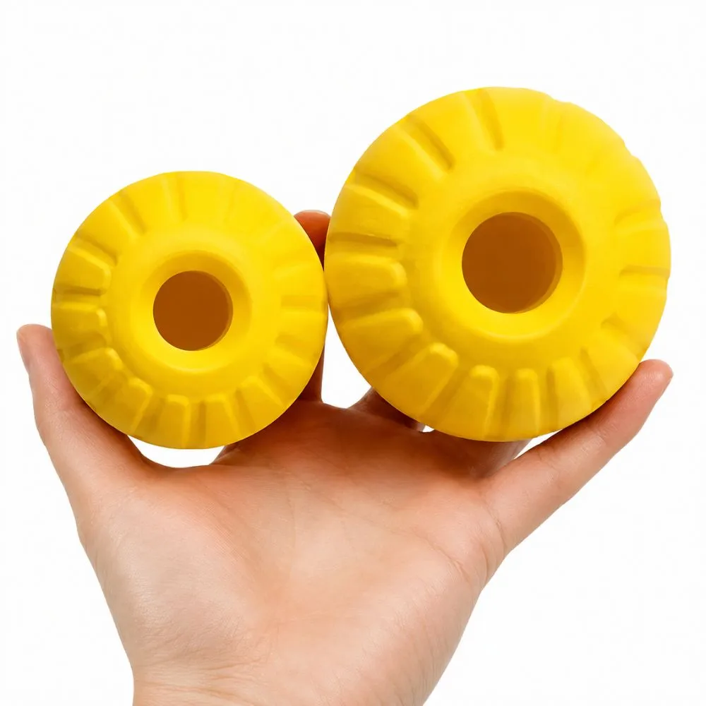 Yellow EVA foam dog balls in two sizes held in a hand