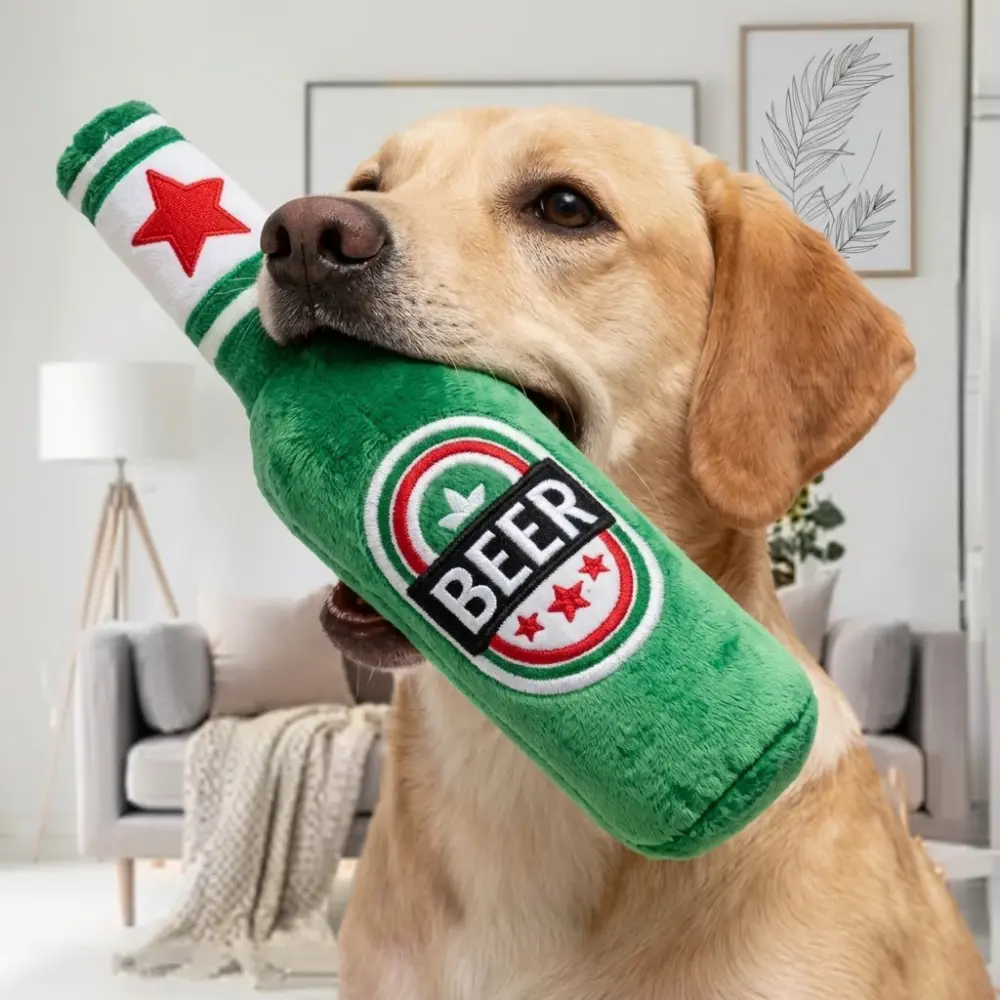 Yellow Labrador holding the green beer bottle dog toy in its mouth