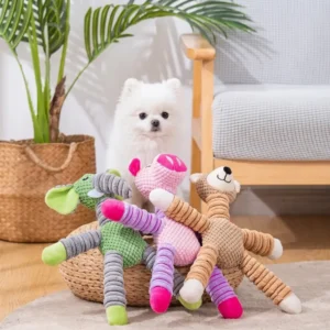 Corduroy squeaky dog toy in elephant and pig designs with a white Pomeranian and bear toy nearby