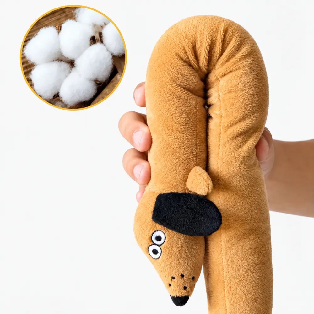 Hand holding the tan dachshund snuffle toy, showing its soft cotton fill