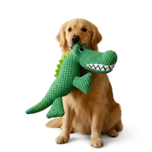 Golden retriever holding a crocodile plush dog toy in its mouth
