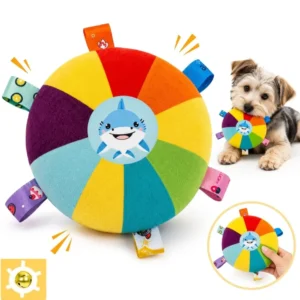 Rainbow shark squeaky plush flying disc dog toy held by a small dog