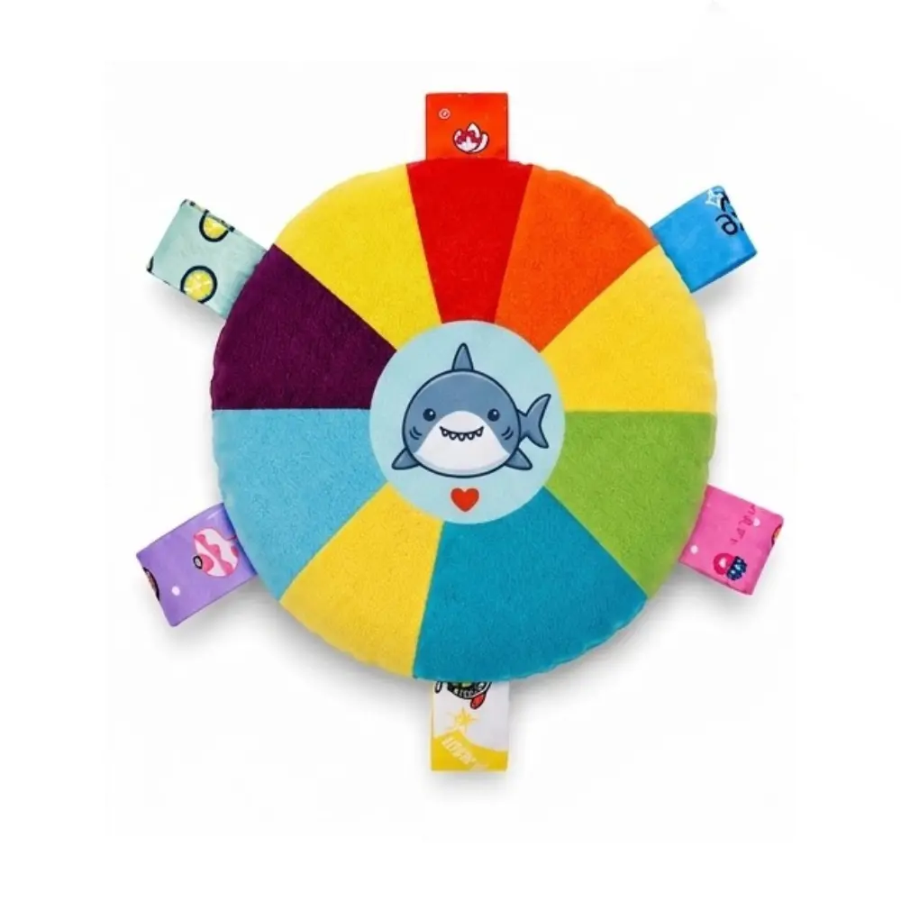 Rainbow shark squeaky plush flying disc dog toy, top view showing fabric grab tabs