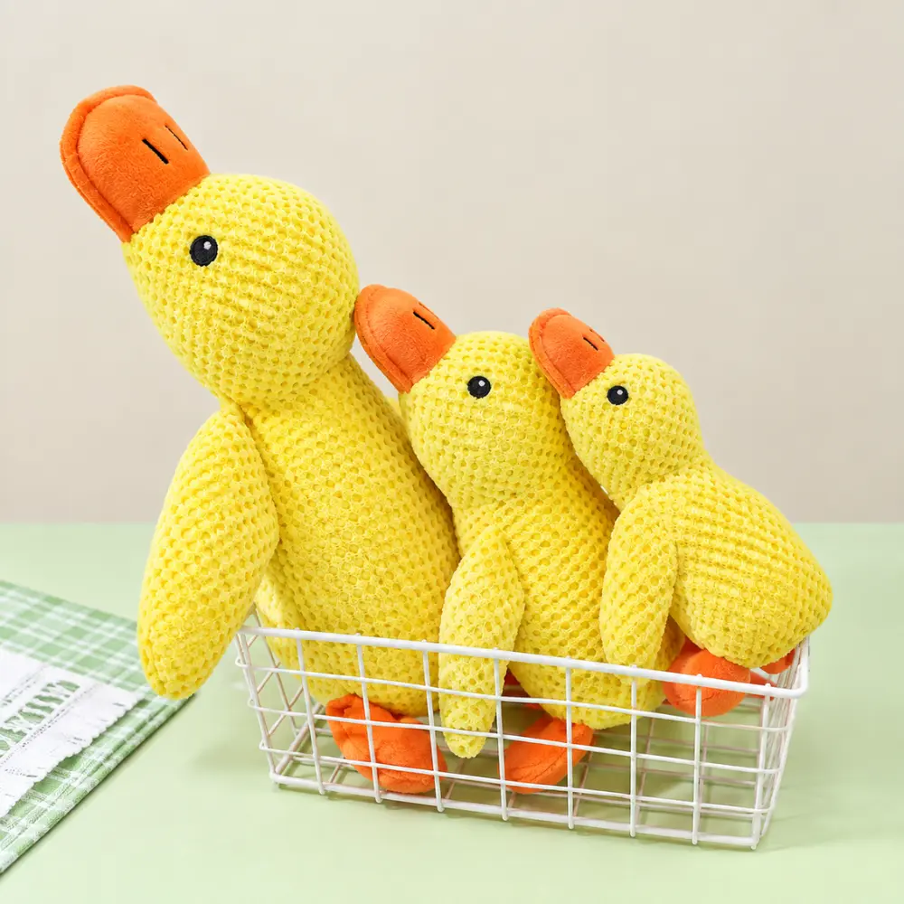 Squeaky yellow duck plush toys sitting together in a wire basket